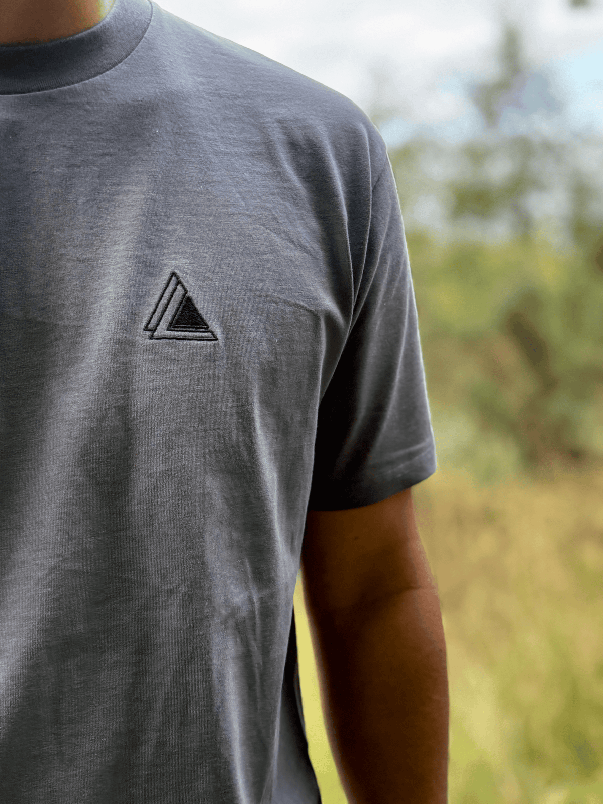 Close-up of the embroidered Stravaig logo on the chest of the Mens Everyday Trail T-Shirt in Haar Grey