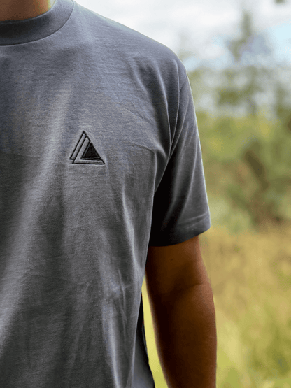 Close-up of the embroidered Stravaig logo on the chest of the Mens Everyday Trail T-Shirt in Haar Grey