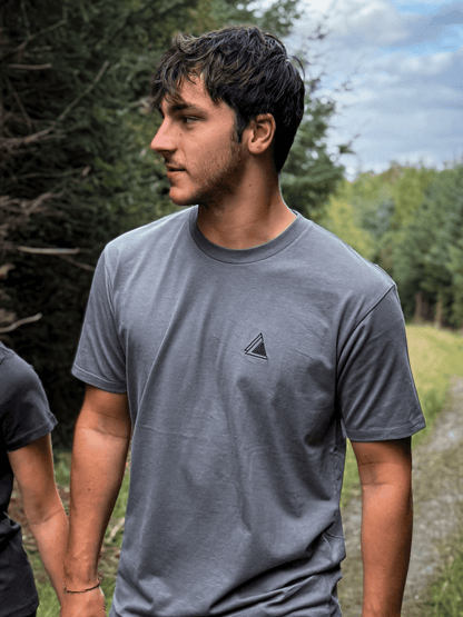 Man in the Haar Grey Stravaig t-shirt standing on a forest trail
