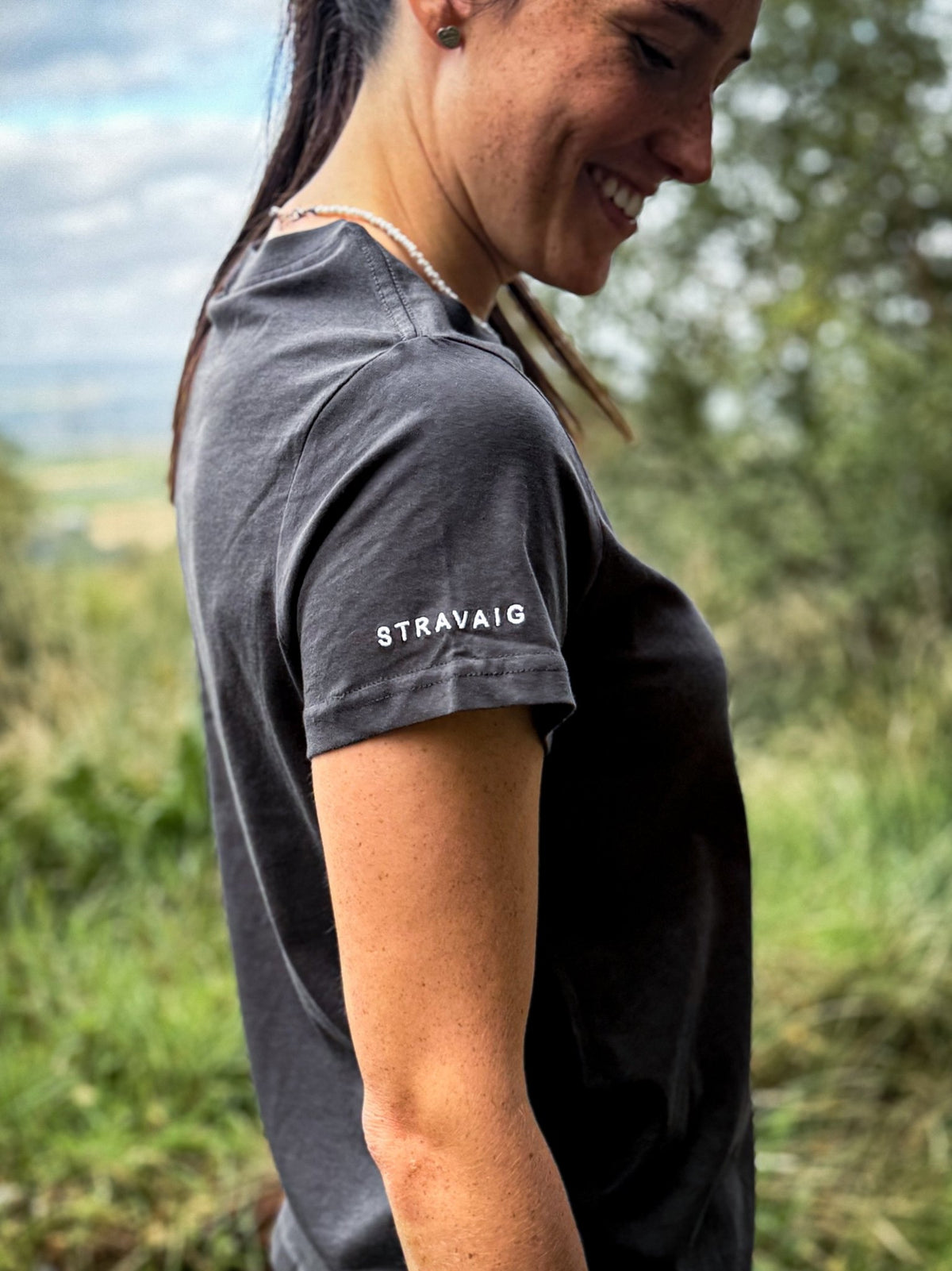 Side view showing the Stravaig sleeve print on the Womens Everyday Trail T-Shirt in Sgàil Grey
